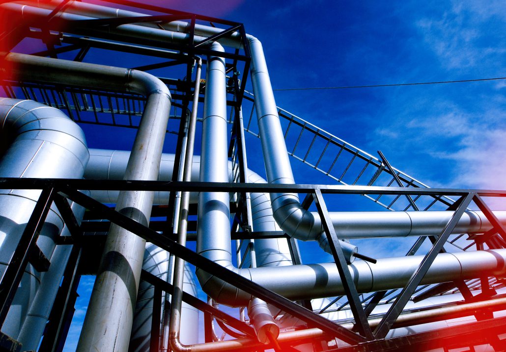 Industrial zone, Steel pipelines and valves against blue sky